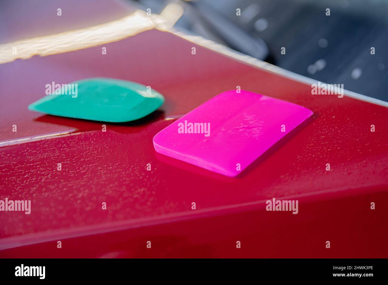 Master man installs vinyl film in risk zone of windshield to protect