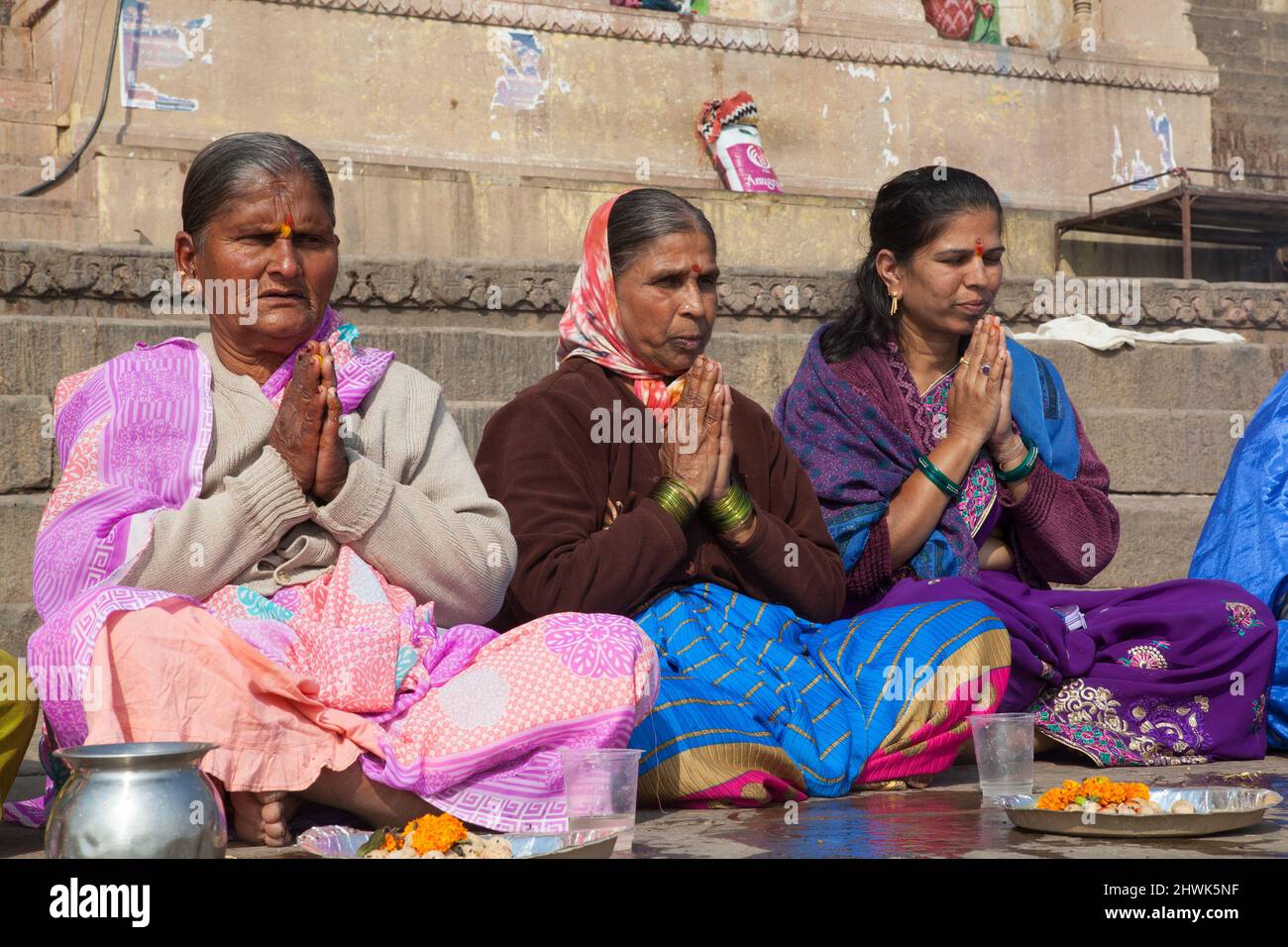Women praying on the ghats at Varanasi Stock Photo