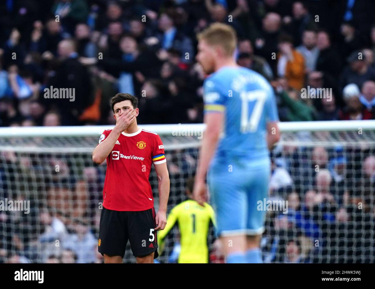 Manchester United's Harry Maguire reacts after Manchester City's Kevin De Bruyne scores their side's second goal of the game during the Premier League match at the Etihad Stadium, Manchester. Picture date: Sunday March 6, 2022. Stock Photo