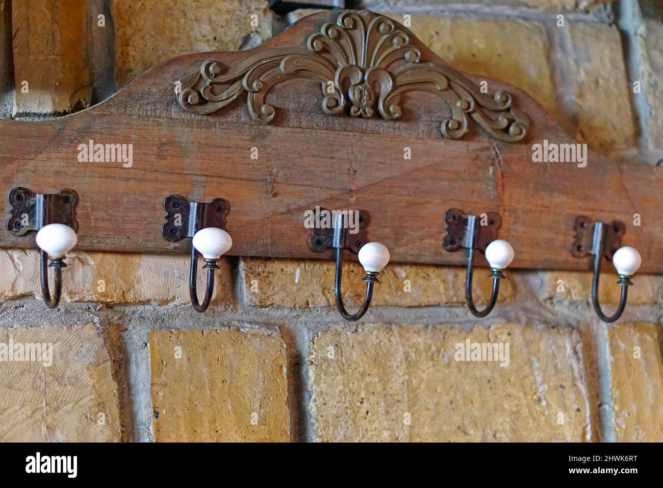 Vintage style coat hooks at old brick wall Stock Photo Alamy