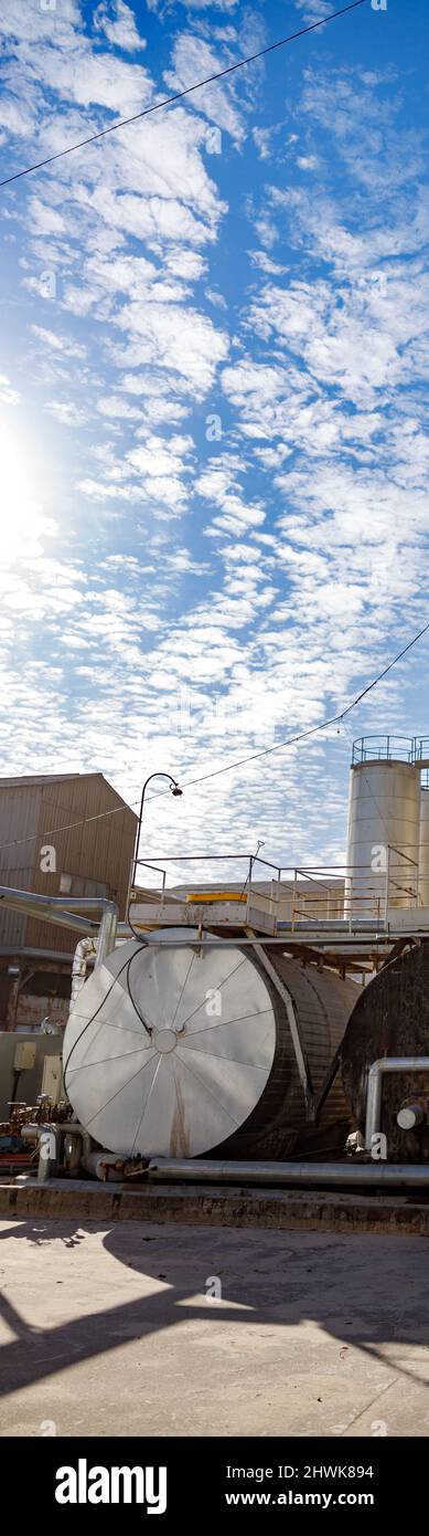Factory with facility complex under blue sky Stock Photo - Alamy