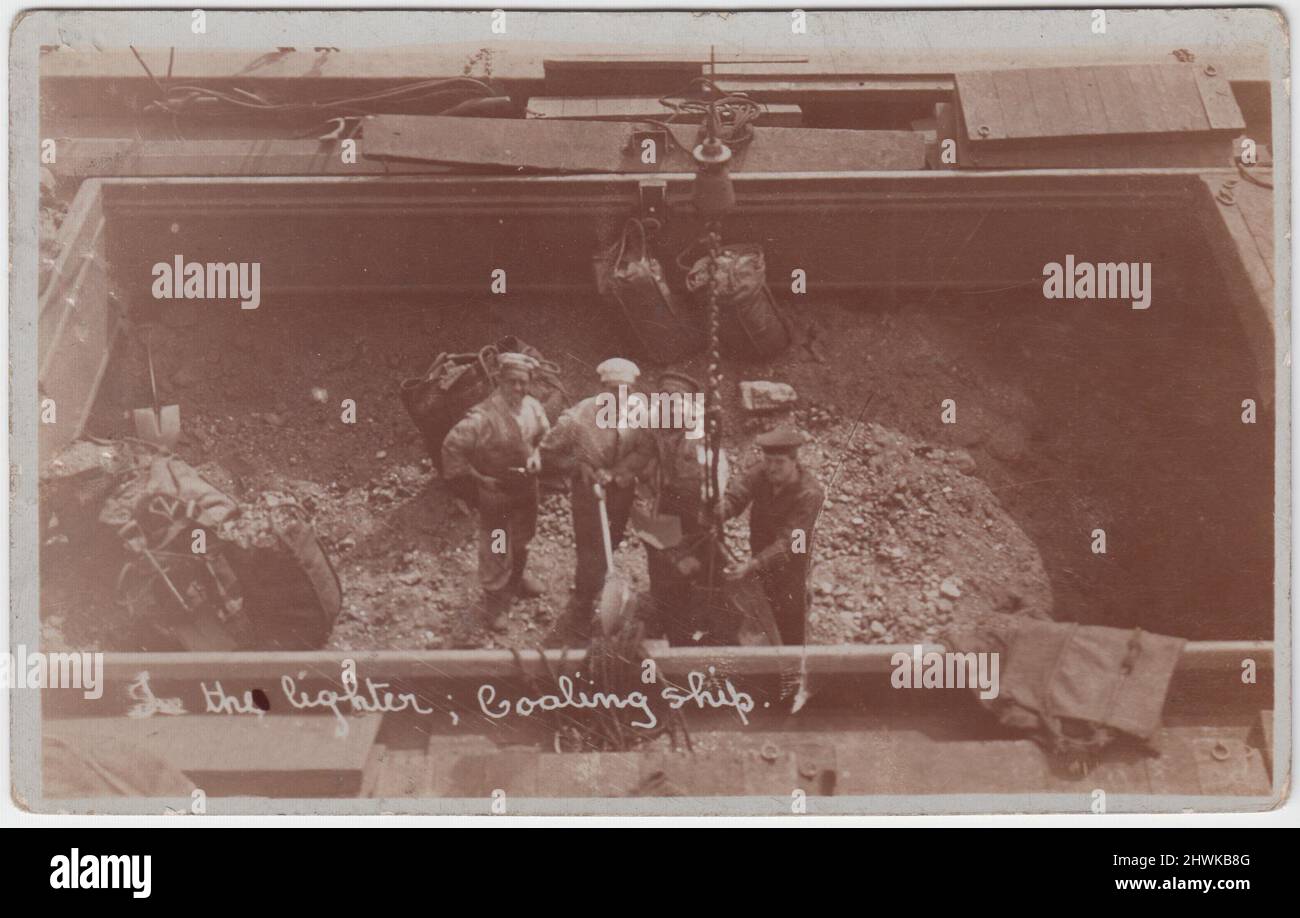 'In the lighter, coaling ship'. Stokers shovelling coal to refuel HMS Cochrane, early 20th century Stock Photo