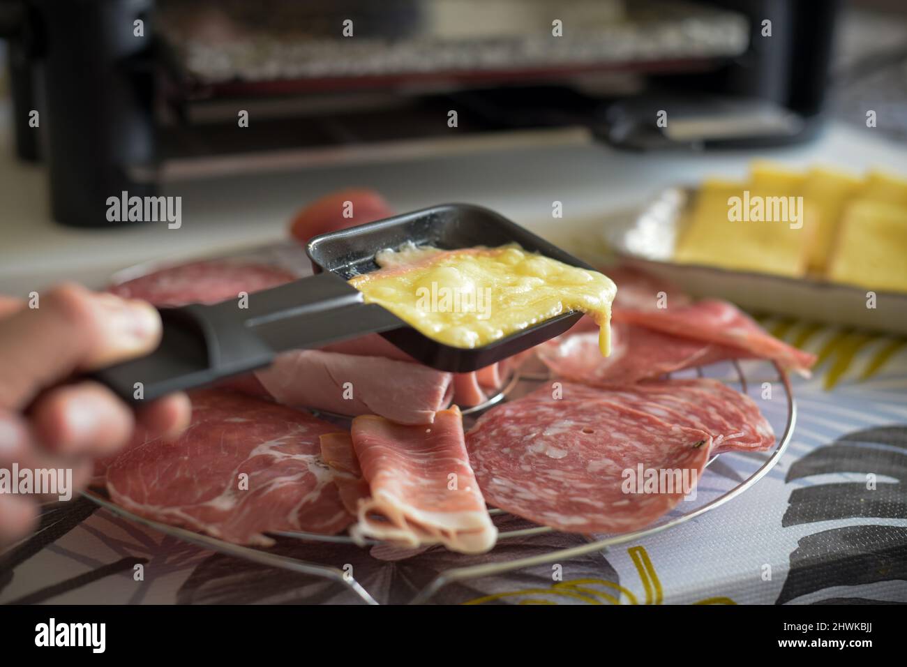 view of a raclette dish at home in france Stock Photo - Alamy