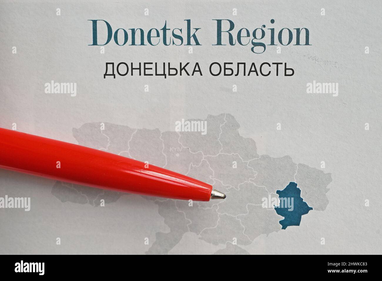 Red ballpoint pen points to Donetsk region in Ukraine on a map Stock Photo