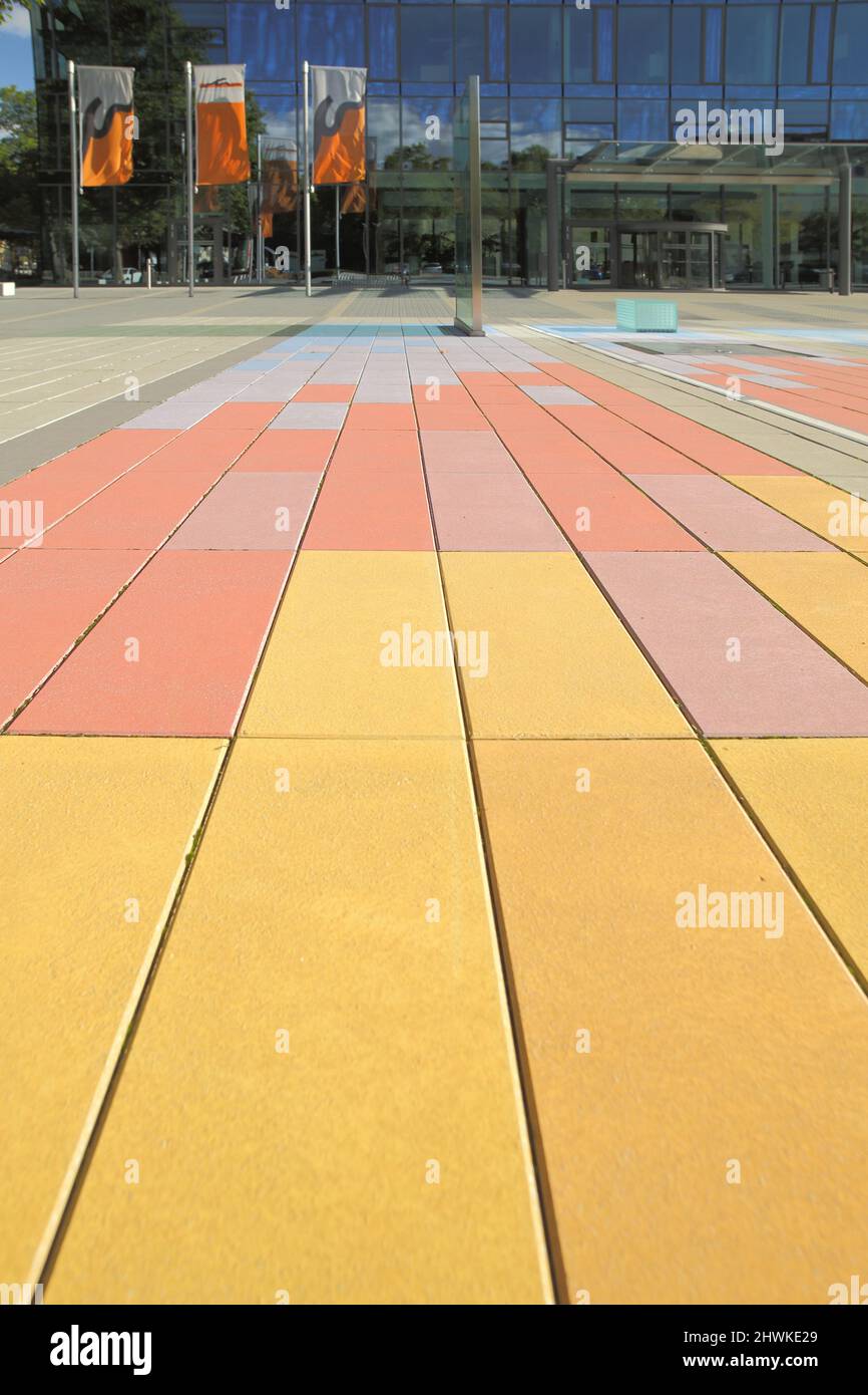 Colored tiles on the ground in front of the Stadtwerke Mainz building, Rhineland-Palatinate, Germany Stock Photo