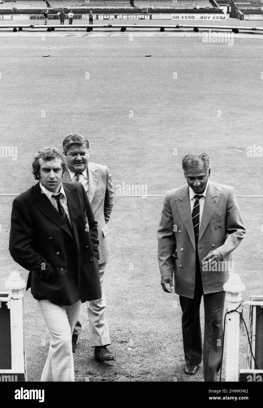 Young England captain David Lloyd (left) Lancashire CCC Secretary Jack Wood and West Indies captain Rohan Kanhai leaving the pitch after the decision that play would not be possible today at Old Trafford.21st July 1973 Stock Photo