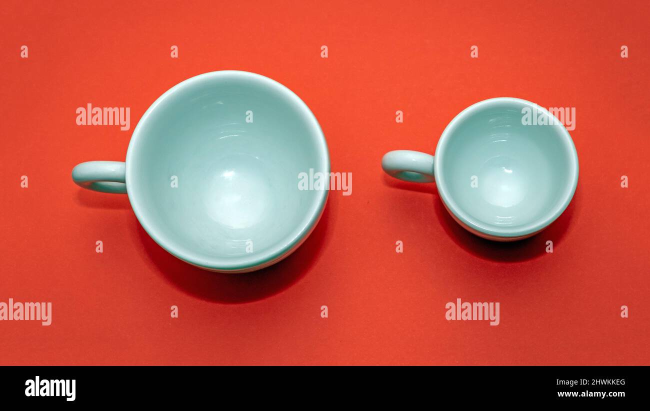 White empty ceramic cups for espresso coffee isolated on red background Stock Photo