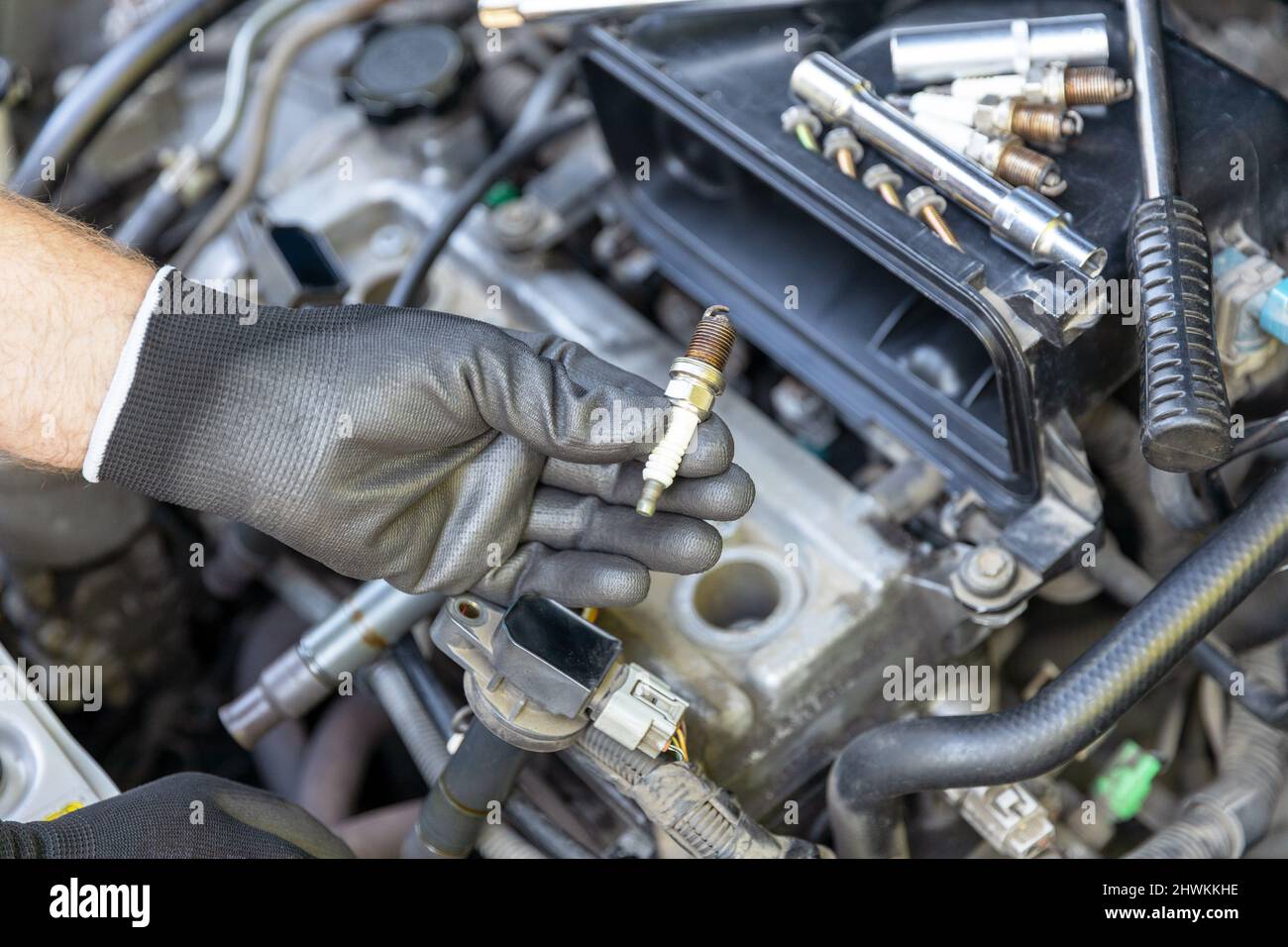 Mechanic changing car spark plugs Stock Photo Alamy