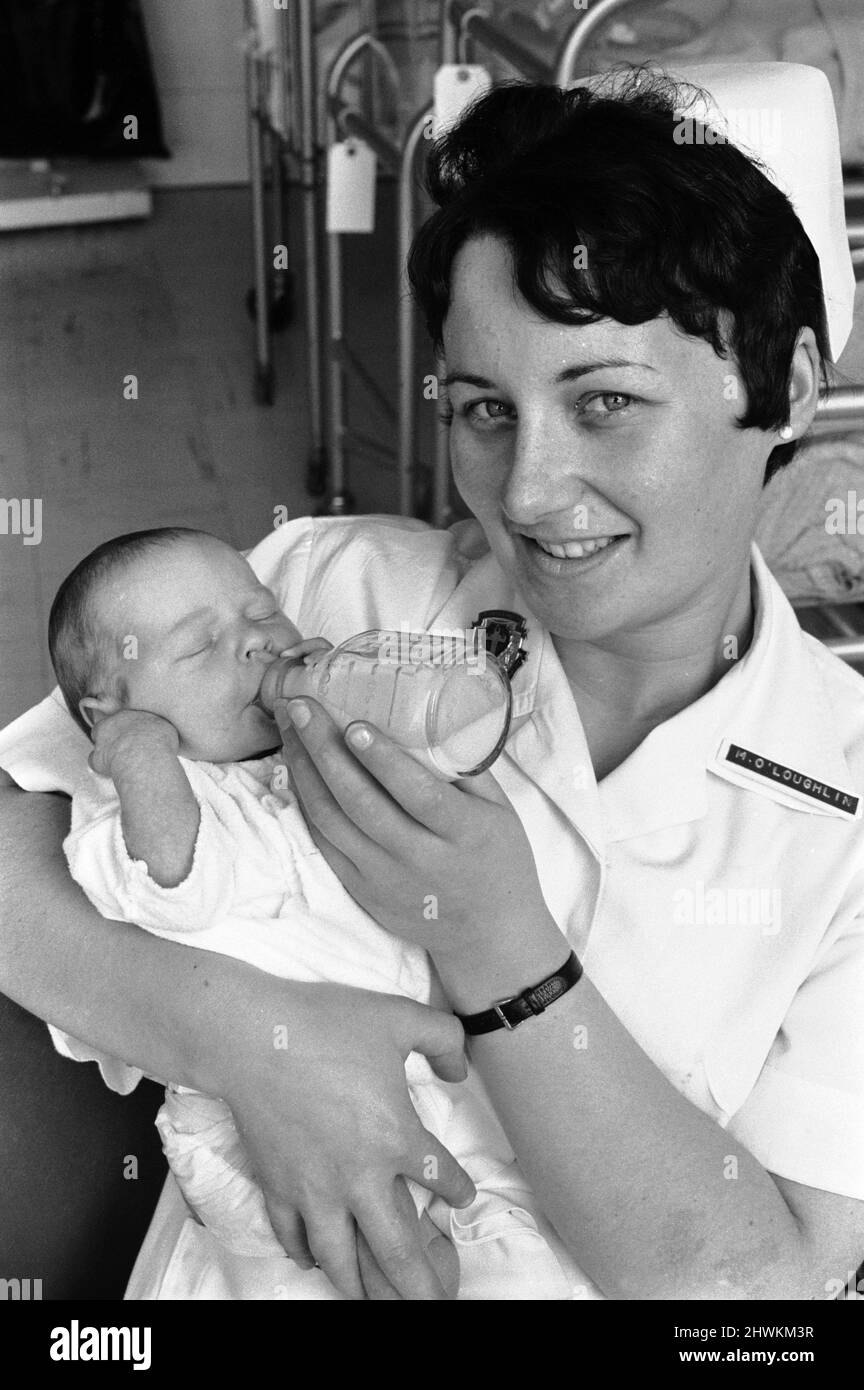 Gertrude Finn, newborn aged 1 week, daughter of  John Finn & Gertrude Finn, pictured with nurse August 1971.    Gertrude, youngest of 20 siblings, is still in hospital and could not make the wedding of her eldest sibling / sister Betty Finn 22 who wed Dermot Healey 27, at Bohernabree, County Dublin, Ireland.    Finn Family Wedding August 1971. Stock Photo