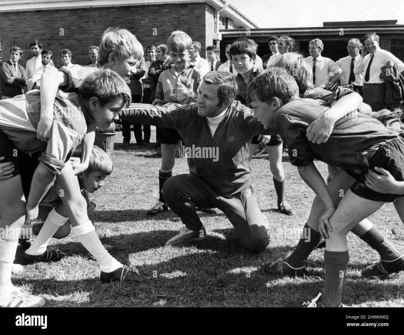 A mini scrum about to form as WRU coaching organiser Ray Williams talks to pupils from Maesglas Junior and St Davids Junior Schools, Newport. The mini rugby is designed for primary schools. 8th September 1971. Stock Photo