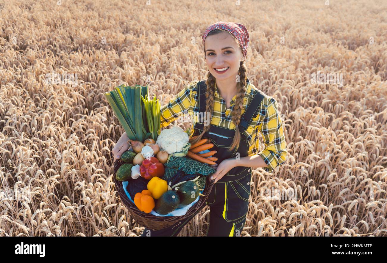 Farmer woman offering healthy vegetables Stock Photo