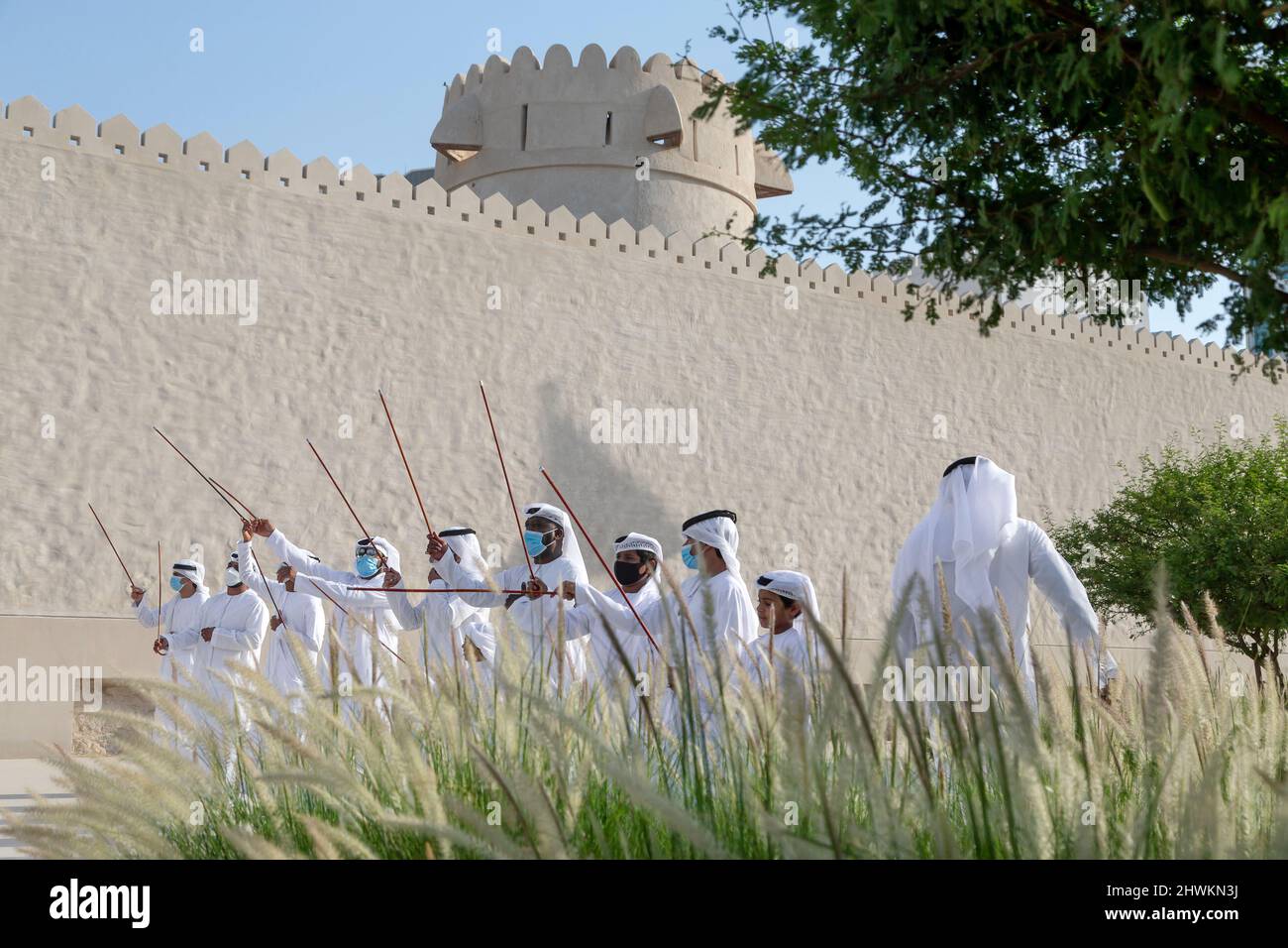 ABU DHABI, UAE - MAY 14, 2021: Traditional Emirati male Al Ayalah dance at Al Hosn Festival, closeup Stock Photo