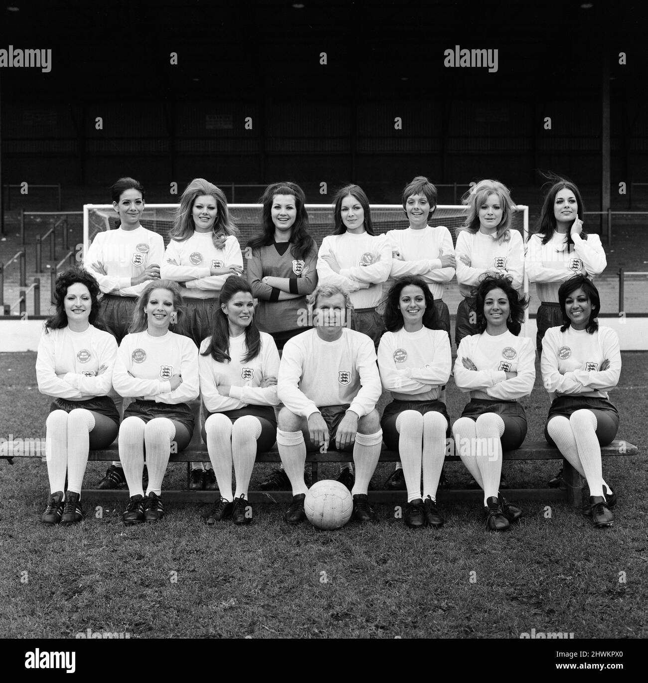 England captain Bobby Moore is pictured his own World Cup team in full England strip. They are Bobby's final choice for the Miss World 1971 contest, unfortunately he could not attend the final himself as he had the little matter of captaining England against Switzerland on the same night as the Miss World contest. They are pictured at West Ham's stadium. Back row, Miss Venezuela Ana Maria, Miss Australia Valerie Roberts, Miss Germany Irene Neumann, Miss Paraguay Rosa Maria Nelgarejo, Miss Brazil Lucia Petterlee, Miss United Kingdom Marilyn Ward, Miss USA Brucene Smith. Front Row, Miss Ireland Stock Photo