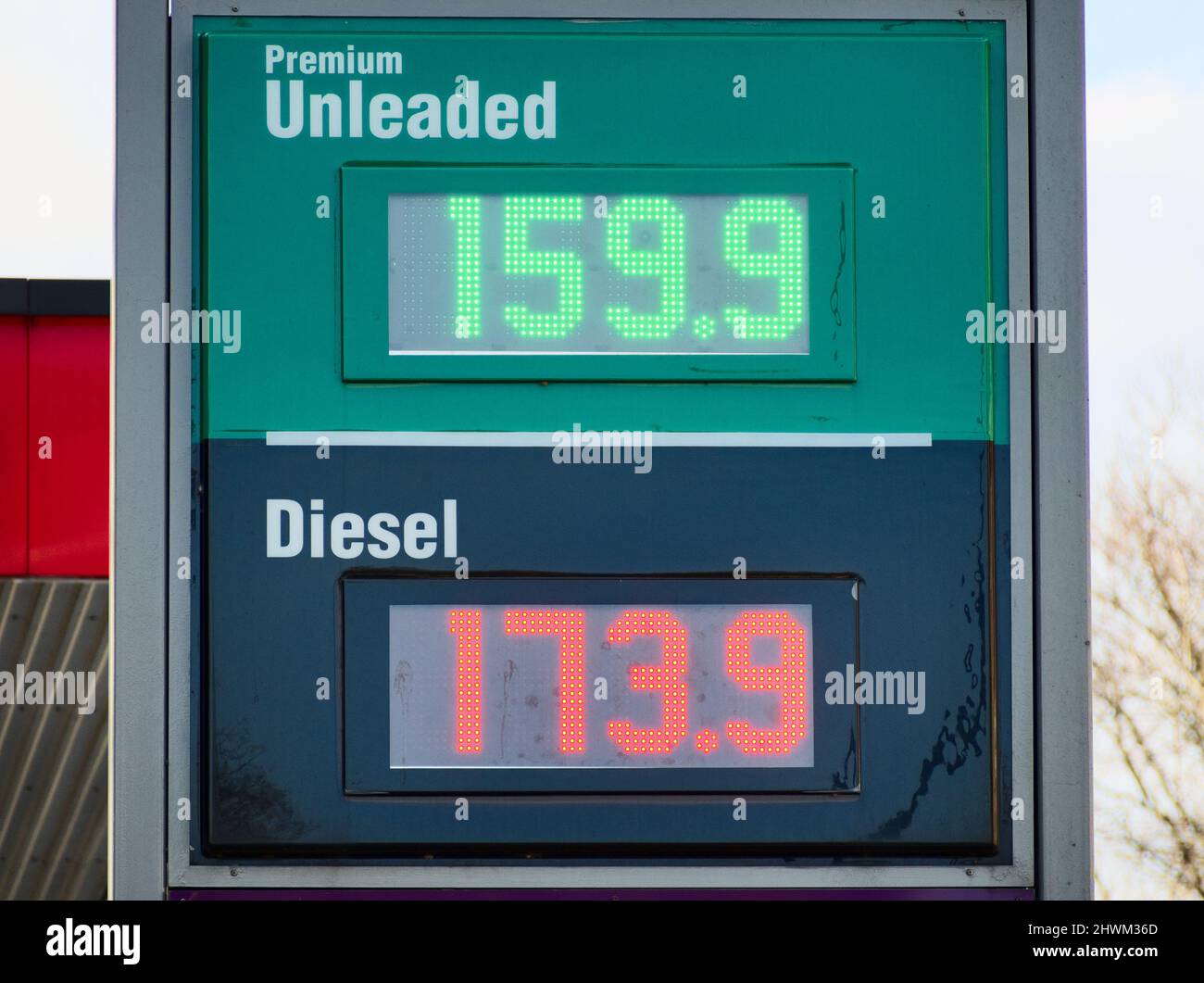 An LED sign at a UK fuel station forecourt on 6th March 2022 shows extremely high fuel prices. Stock Photo