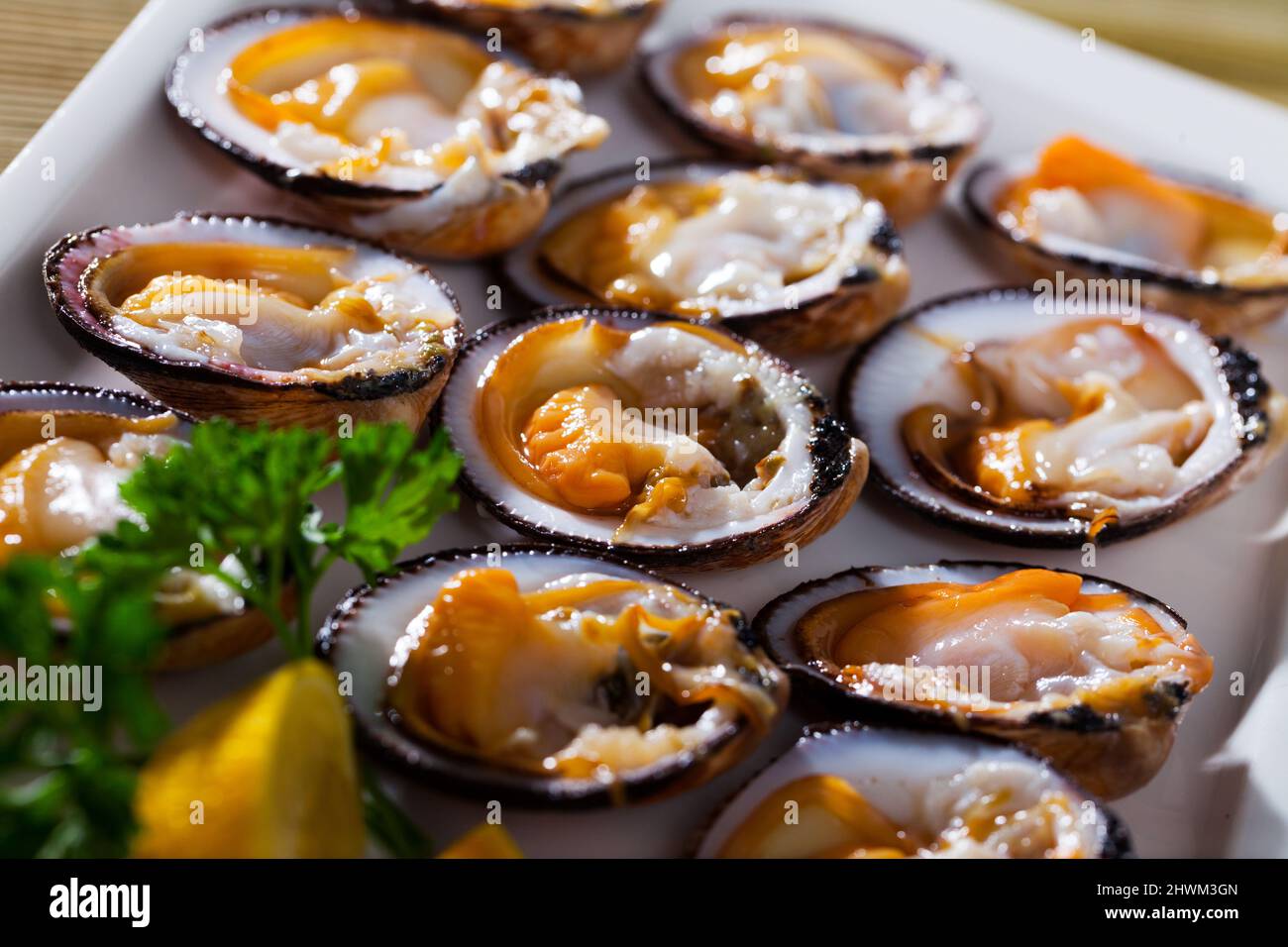 Raw dog cockles with greens and lemon Stock Photo Alamy