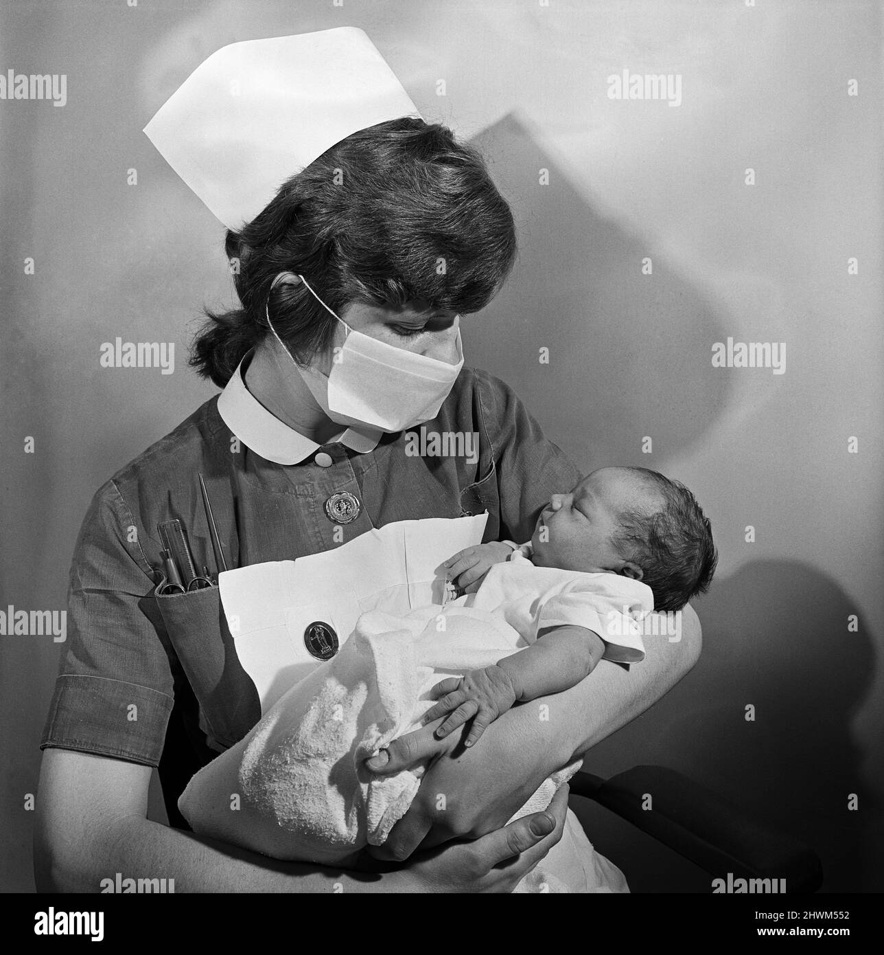 A nurse holding a baby at Carter Bequest hospital. Circa 1973. Stock Photo