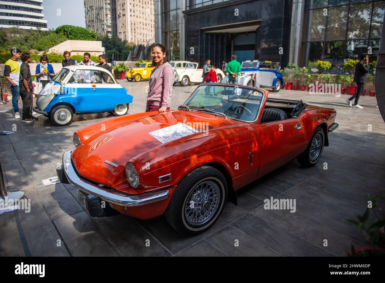 New Delhi, India. 06th Mar, 2022. A young lady poses next to a 1970 made Triumph car during The Statesman and VCCI (Vintage and Classic Car Club of India) Vintage Car display held at The Statesman House. Credit: SOPA Images Limited/Alamy Live News Stock Photo