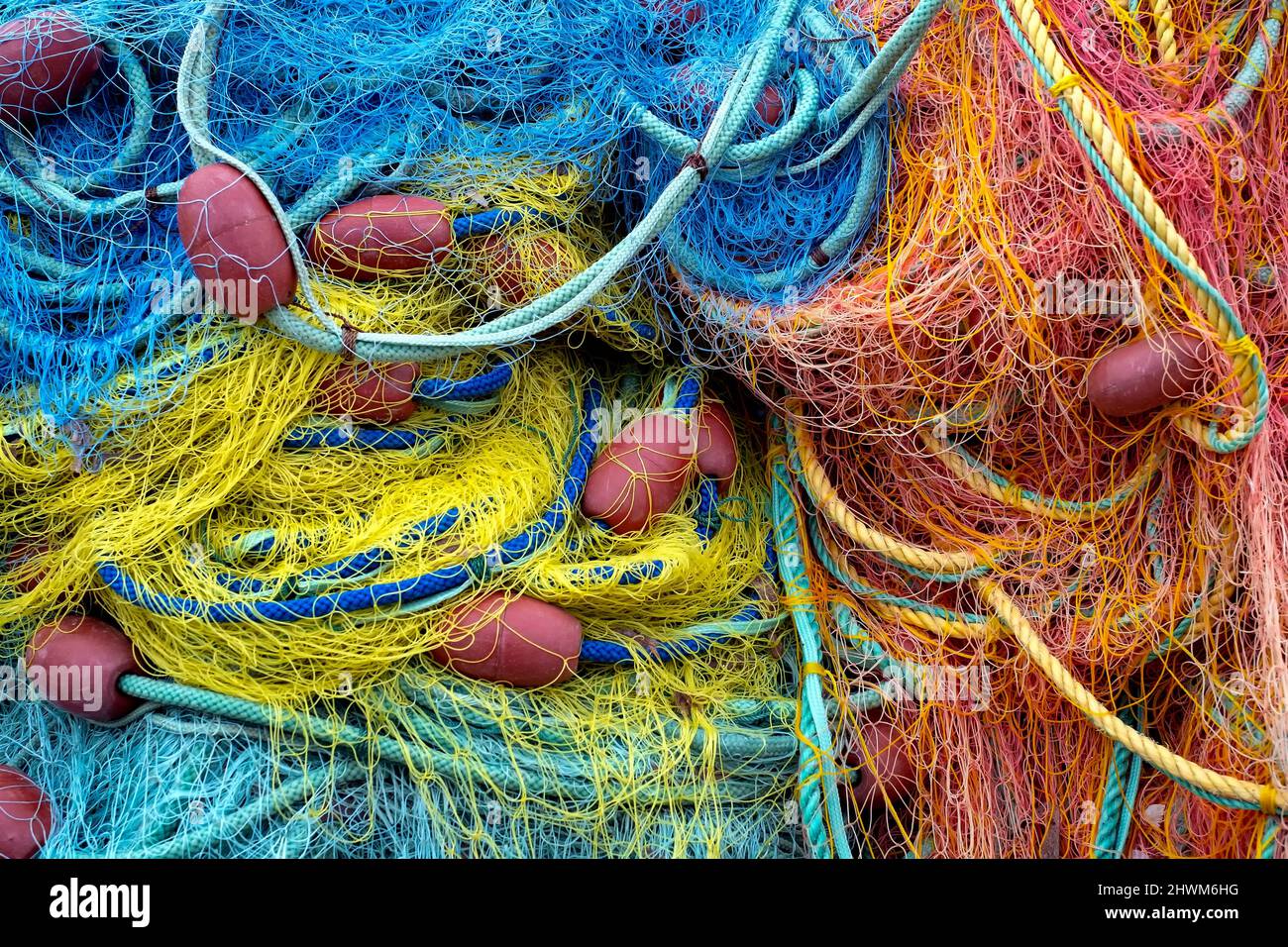 Colourful fishing nets with red buoys Stock Photo
