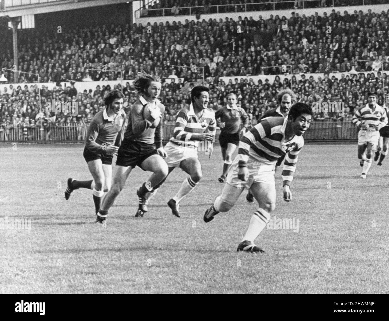 Wales XV 62-14 Japan, Rugby Union International match at Cardiff Arms Park, Cardiff, Wales, Saturday 6th October 1973. 1973 Japan rugby union tour of Wales, England and France. Our Picture Shows ... full back John Williams has the japanese on the run as he swerves through their defence. Stock Photo