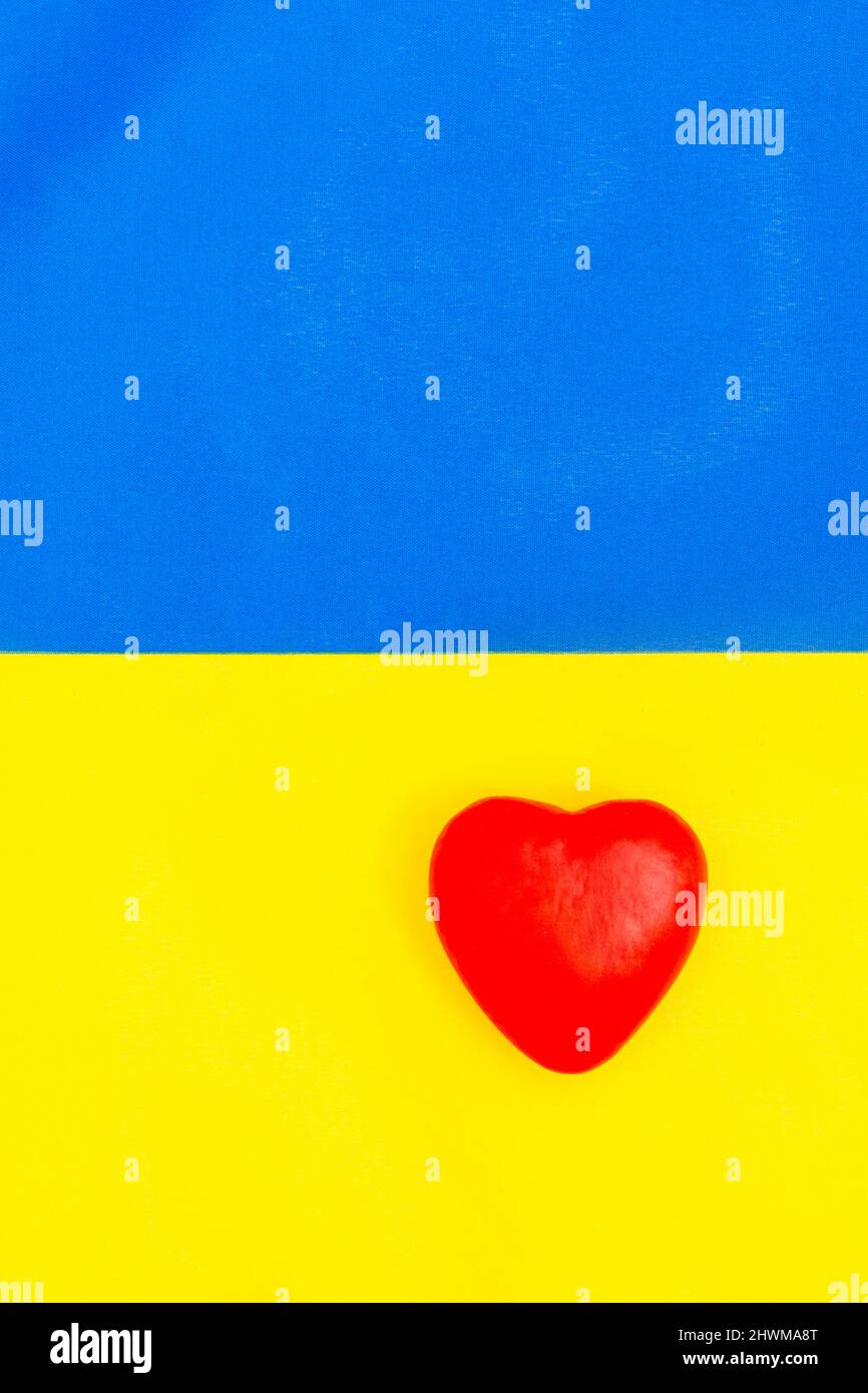 Blue and yellow Ukraine flag with heart shape. For support for Ukraine against Russian invasion, spirit of Ukrainian people, solidarity with Ukraine. Stock Photo