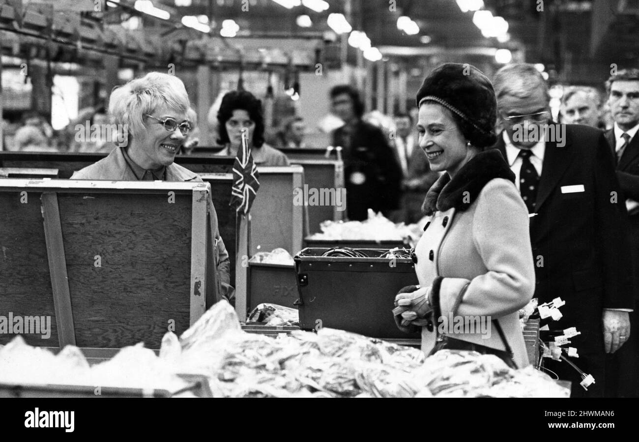 Queen Elizabeth II pauses to talk to one of the women on the assembly line during her walkabout at the Hoover factory in Merthyr. 9th March 1973. Stock Photo