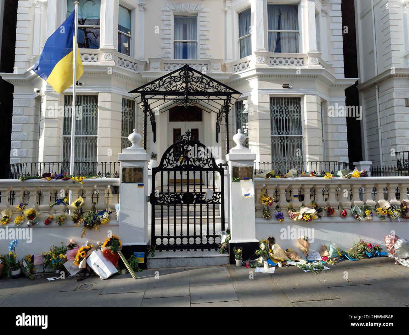 View of the Ukraine Embassy in Holland Park London with many flowers and banners during the Russian invasion of Ukraine Stock Photo