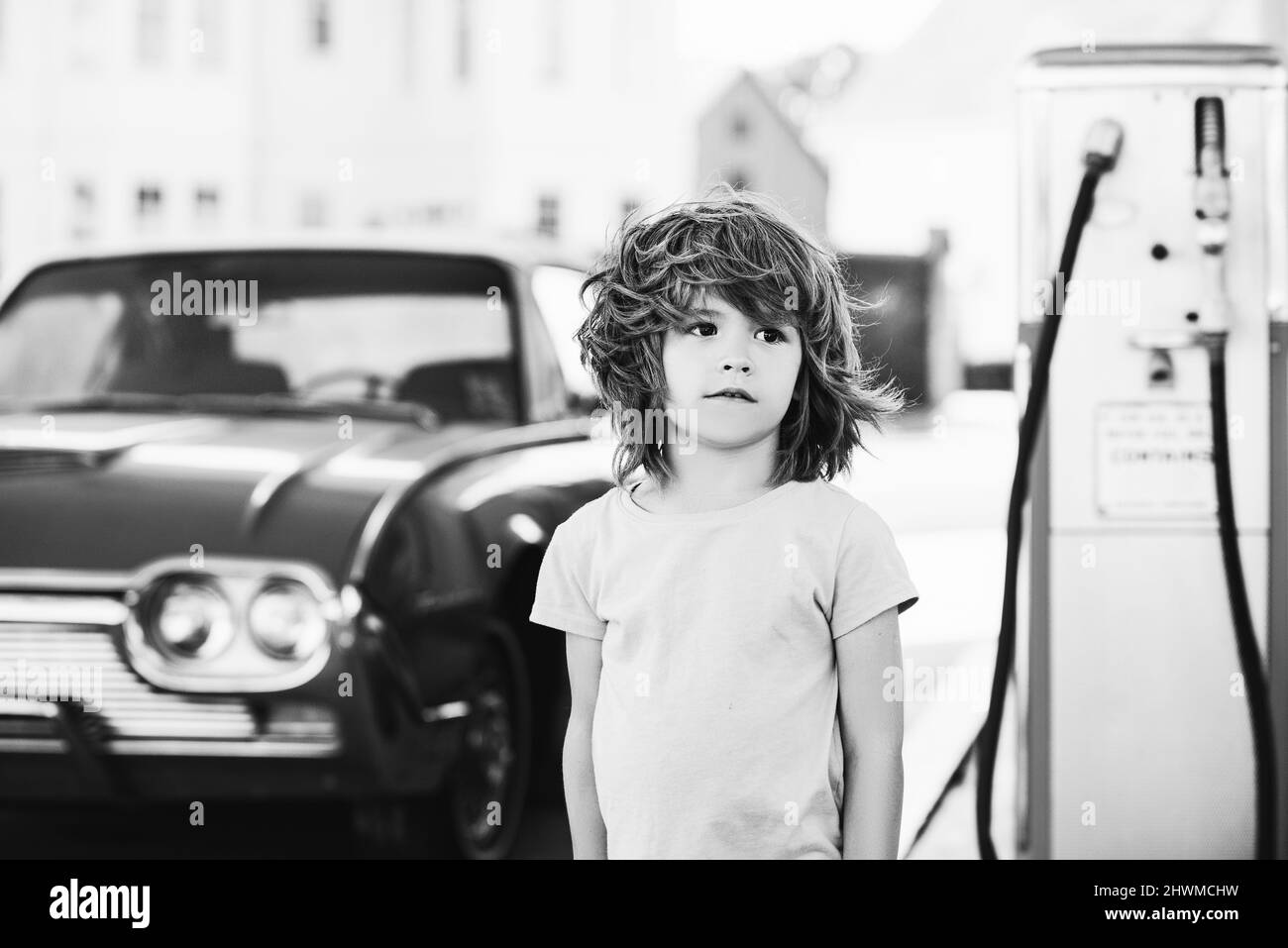 Kid at the gas station. Retro automobile. Stock Photo