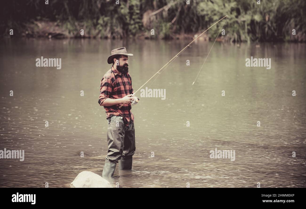 Male fishing on the lake. Relax in natural environment. Good profit. Carry on fishing. Man relaxing and fishing by lakeside. If wishes were fishes Stock Photo