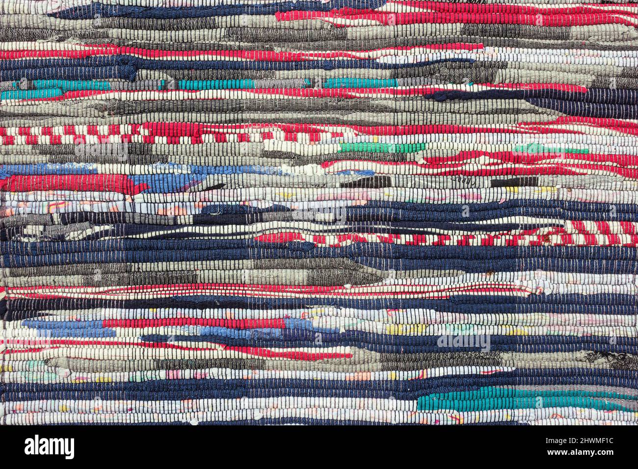 Multi striped colored textile homespun rug. Closeup. Background Stock Photo
