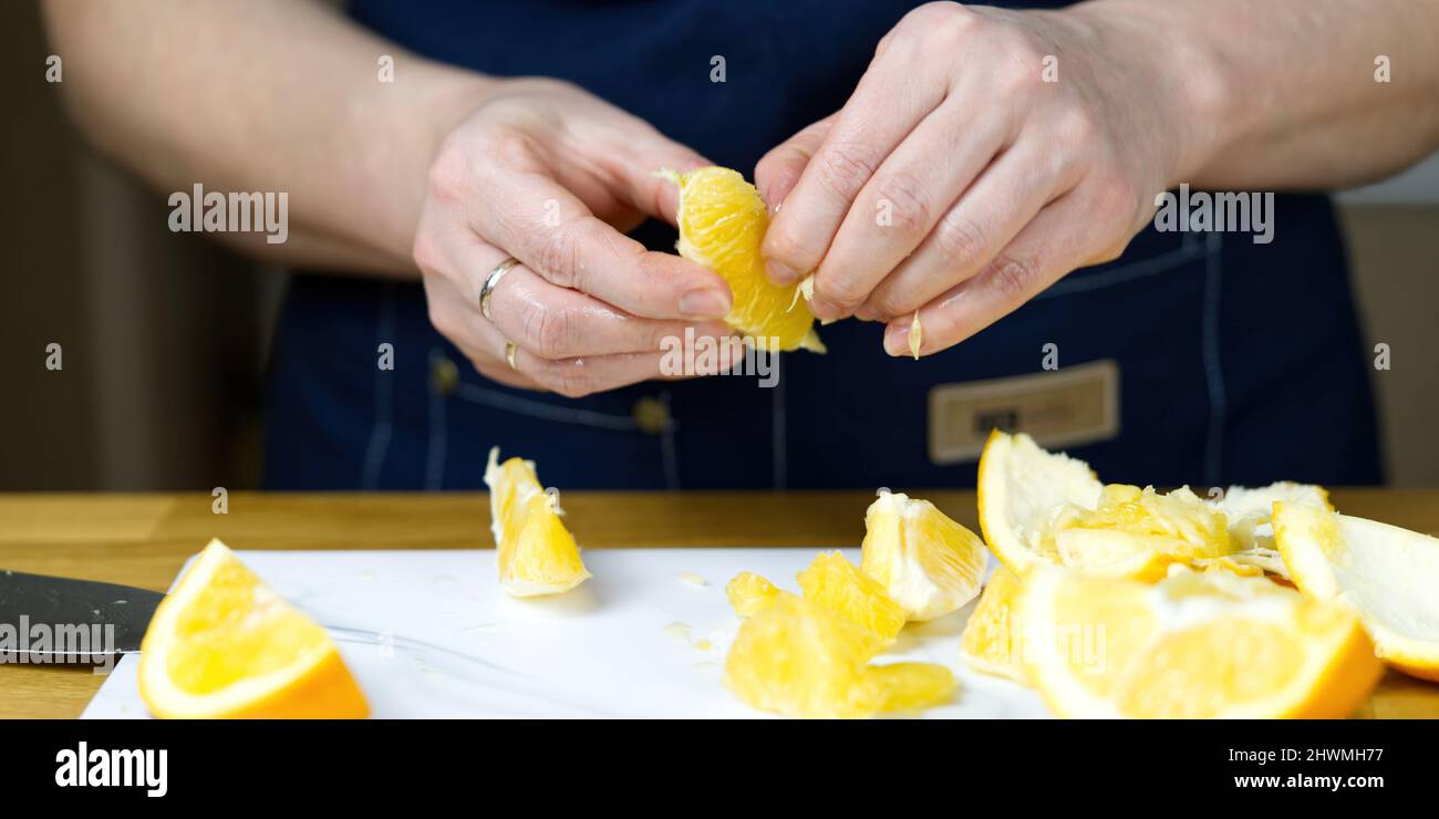 Hands peeling oranges hi-res stock photography and images - Alamy
