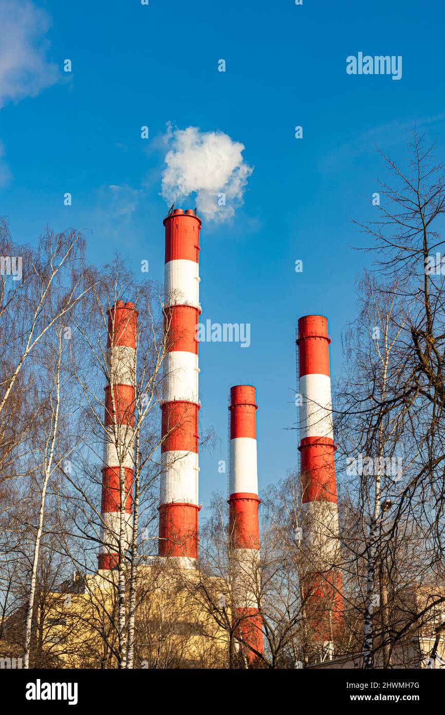 Moscow, Russia - March 02, 2022: red boiler pipe against the blue sky Stock Photo