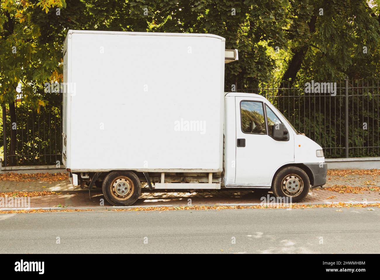 An old cargo van parked on a city street. Old retro vintage and
