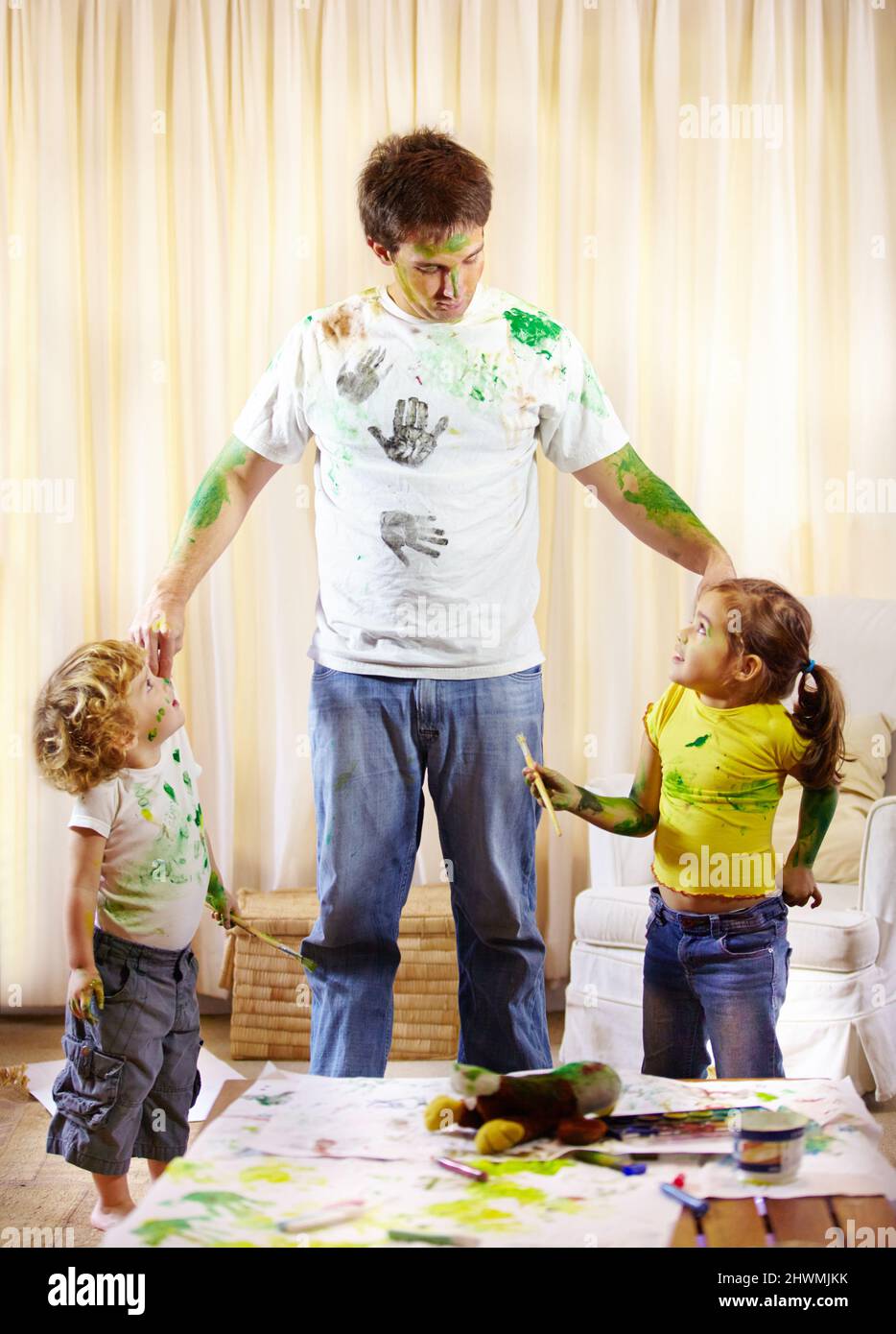 You two have some explaining to do. Shot of a paint covered father