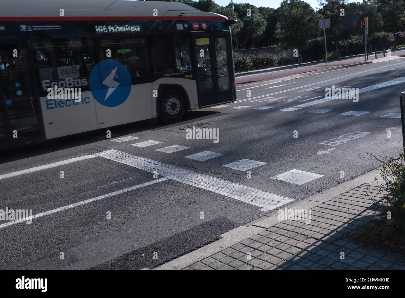 Barcelona, Spain: Bus on the road with zebra crossing sign Eco Bus Electric Stock Photo