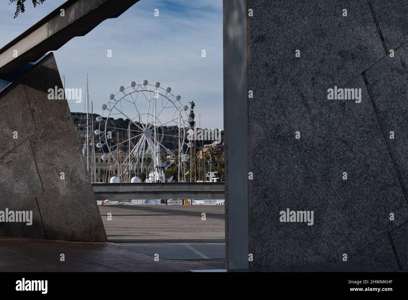 Ferris wheel and Columbus Monument at Port Vell in Barcelona, Spain. Stock Photo