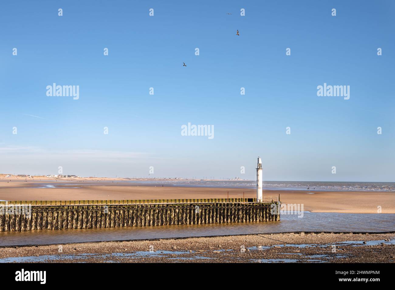 Entrance of Rye Harbour, beacon on the mouth of the river Rother looking towards Cumber sands Stock Photo