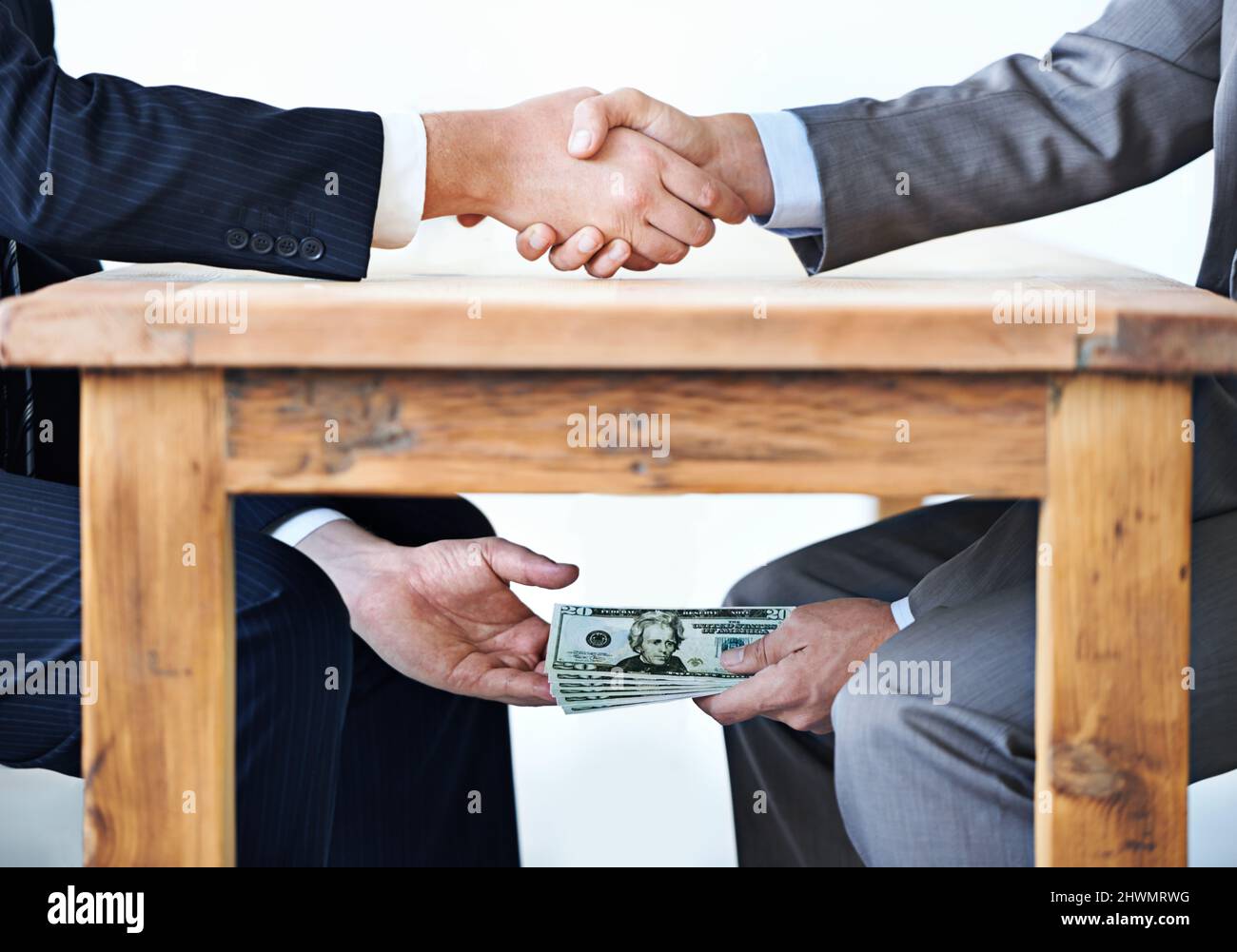 Underthetable transactions.... Cropped shot of two businessmen