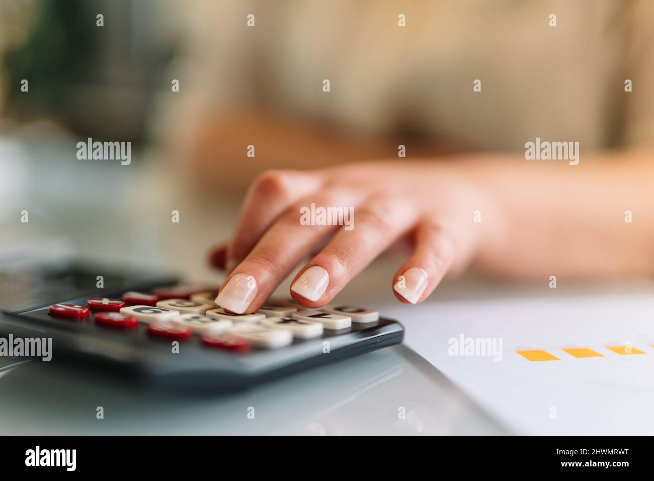 Young girl using a calculator at the office Stock Photo