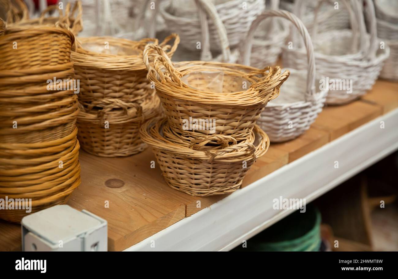 Wicker baskets on shelves in store Stock Photo