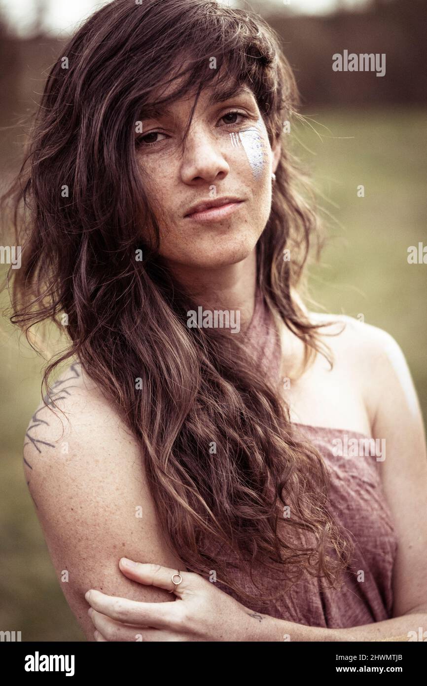 strong natural woman with long wild hair and facepaint Stock Photo