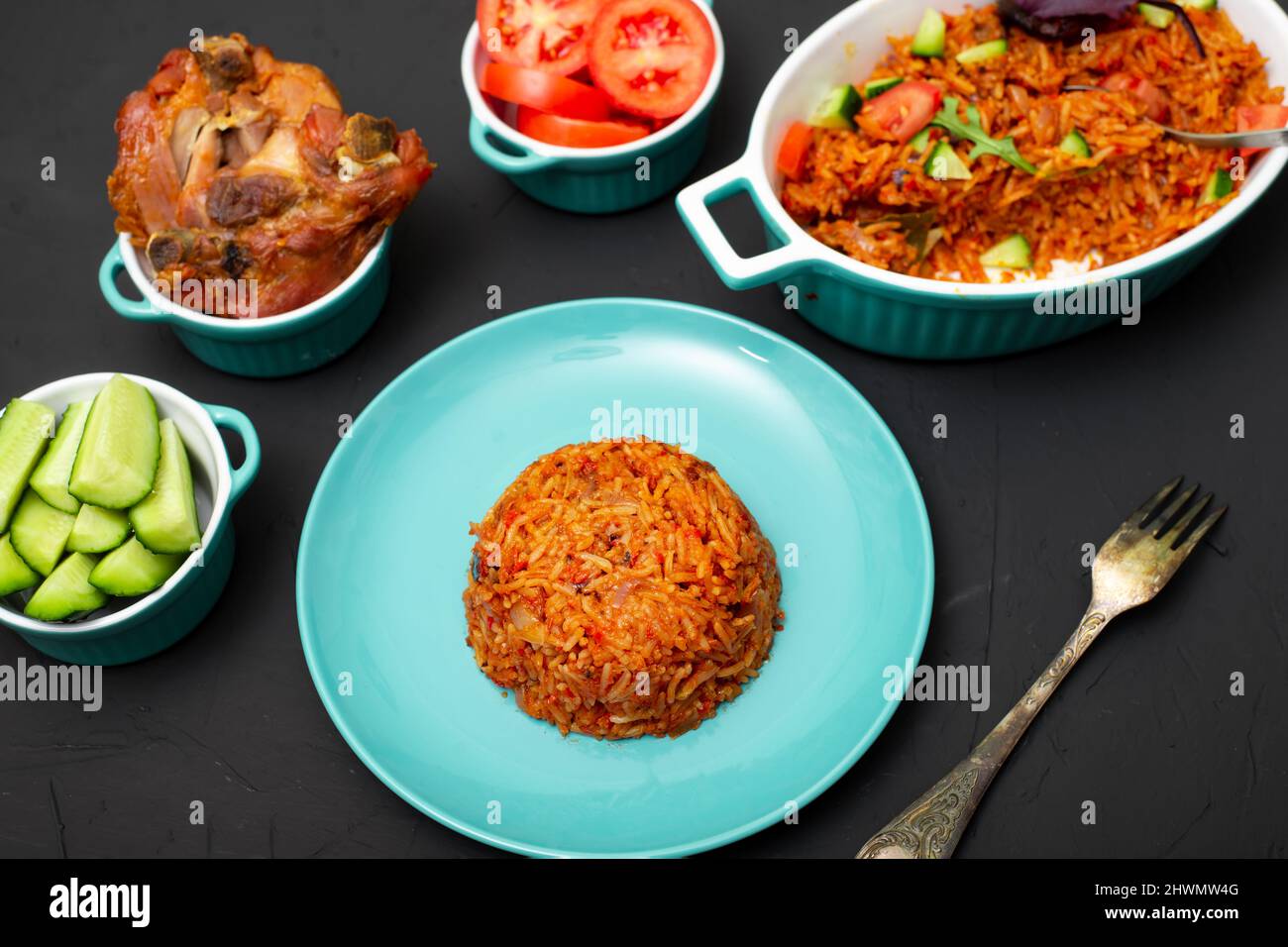 Jollof rice on a plate. Rice with tomatoes, onions, spices. Traditional ...