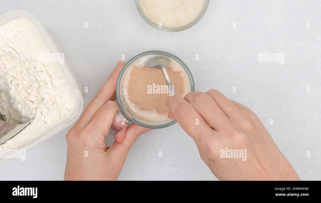 Bread dough recipe. Mixing dry yeast and sugar in warm milk, step by