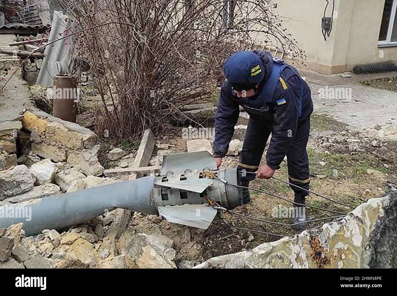 Mykolaiv, Ukraine. 06th Mar, 2022. Security personnel inspect the remains of a military weapon on a street Mykolaiv, southern Ukraine, on Sonday on March 6, 2022. photo by State Emergency Services Of Ukraine/ Credit: UPI/Alamy Live News Stock Photo