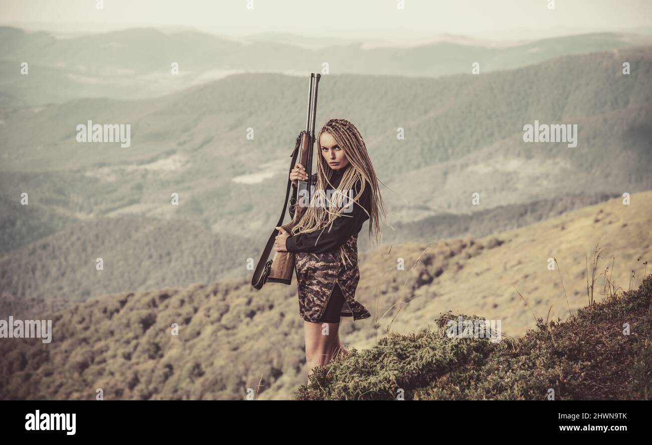Hunter woman with a hunting rifle gun in the autumn forest. Calibers of ...