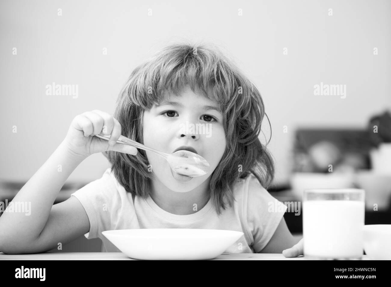 Child eating healthy food. Cute little boy having soup for lunch. Child nutrition. Stock Photo