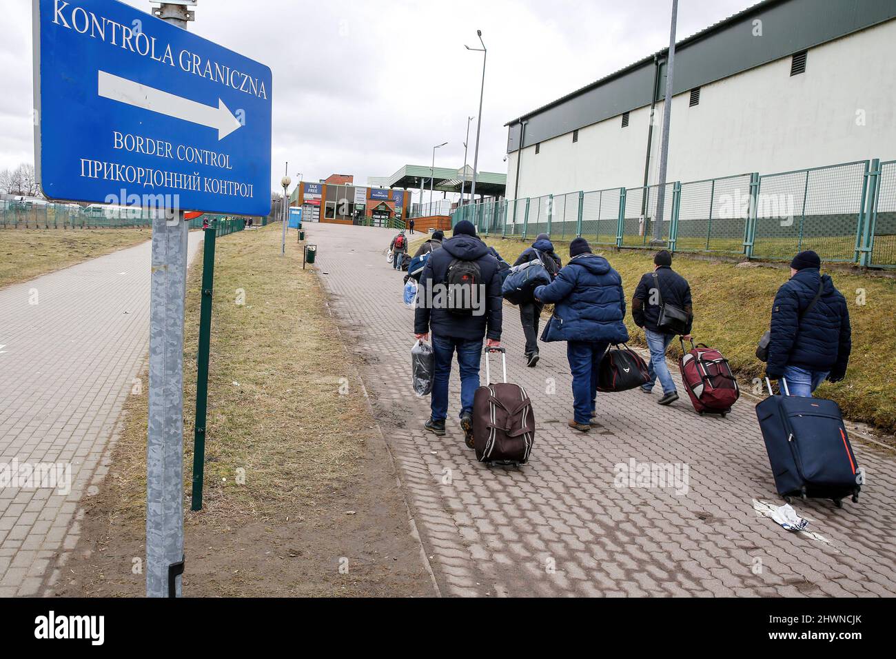 Medyka, Poland. 05th Mar, 2022. Ukrainians walk towards the passport control at the border crossing in Medyka. More than 500 thousand people already fled Ukraine for Poland. As the Russian Federation army crossed Ukrainian borders the conflict between Ukraine and Russian is expected to force up to 4 million Ukrainians to flee. Many of the refugees will seek asylum in Poland. Most escapees arrive to border towns like Przemysl and are relocated to inner cities. Credit: SOPA Images Limited/Alamy Live News Stock Photo