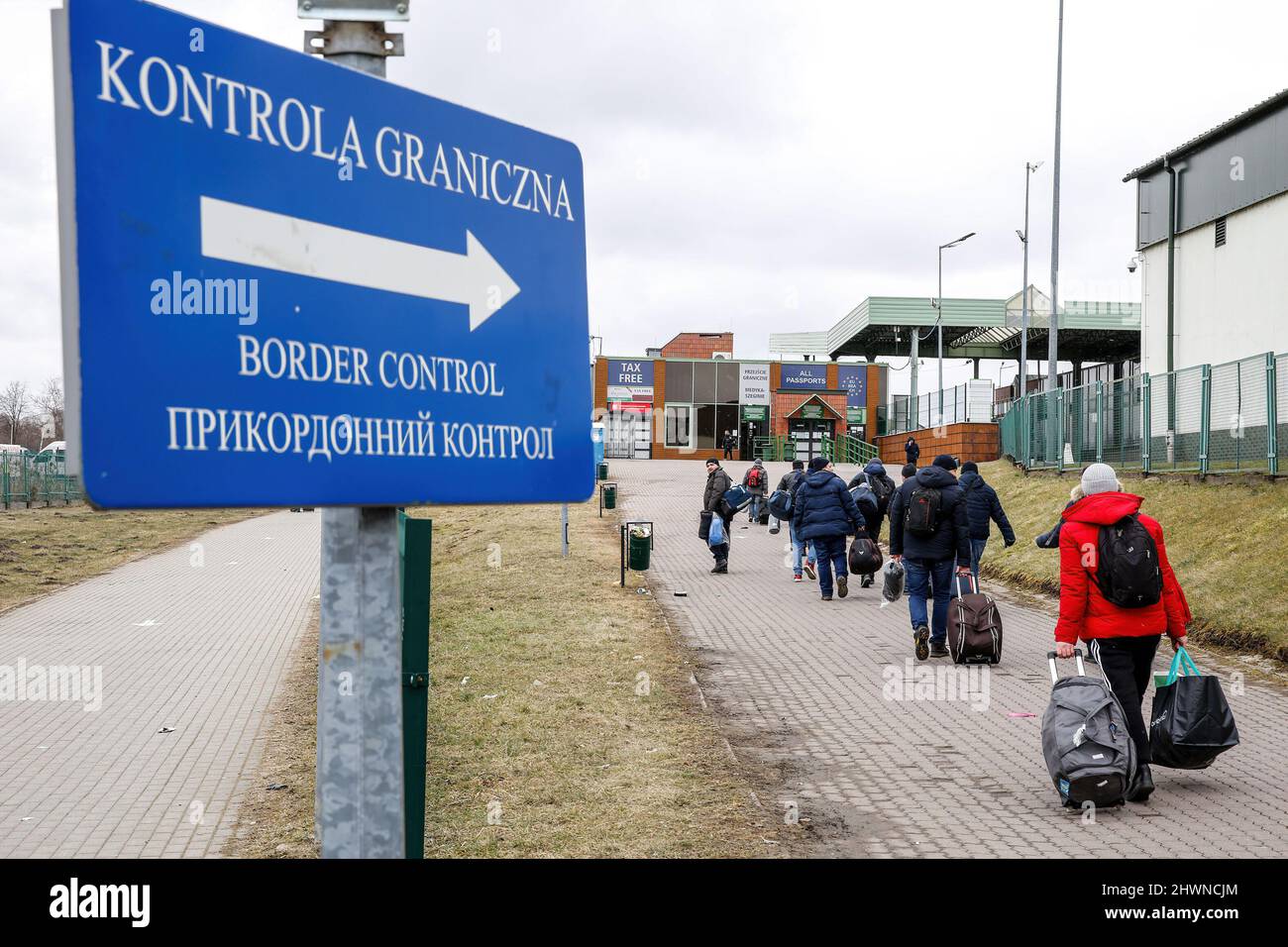 Medyka, Poland. 05th Mar, 2022. Ukrainians walk towards the passport control at the border crossing in Medyka. More than 500 thousand people already fled Ukraine for Poland. As the Russian Federation army crossed Ukrainian borders the conflict between Ukraine and Russian is expected to force up to 4 million Ukrainians to flee. Many of the refugees will seek asylum in Poland. Most escapees arrive to border towns like Przemysl and are relocated to inner cities. Credit: SOPA Images Limited/Alamy Live News Stock Photo