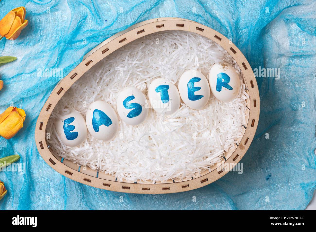 Happy easter time. Bright Easter holiday concept with spring flowers and easter eggs. Colorful Easter eggs background Stock Photo