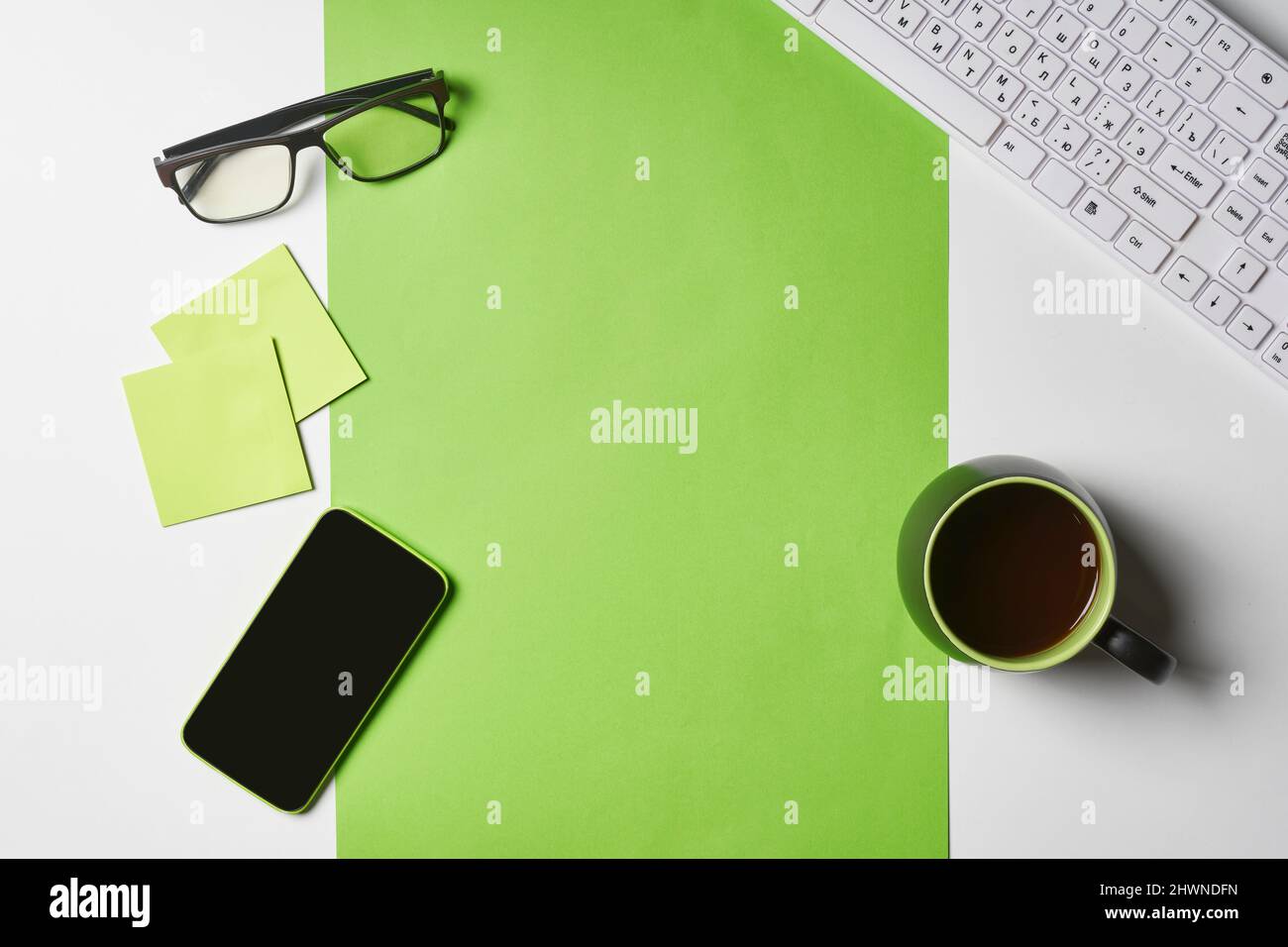 Bright office workspace. Work space with notepad, keyboard, coffee and glasses. Work space table desk. Flat lay, top view, copy space Stock Photo