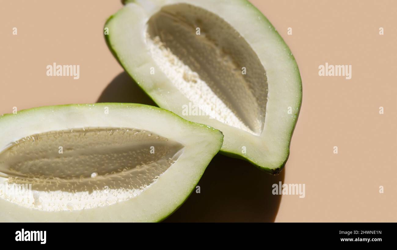 green papaya on beige background Stock Photo